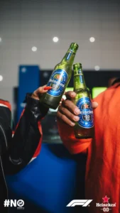 Two people toasting with Heineken 0.0 bottles