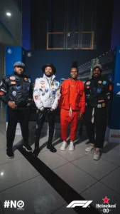 Group of people in F1 outfits.