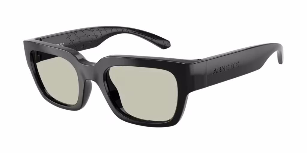 A pair of black, bold square-framed sunglasses with light grey lenses, viewed from an angle.