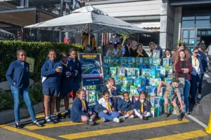Children posing in front of the milk for the Supercar Run