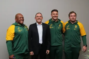 Hyundai Springboks partnership. Springbok rugby players and officials posing together, wearing green and yellow uniforms.