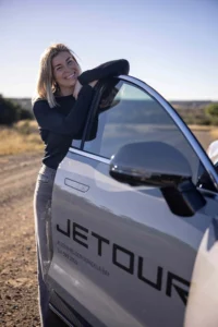 Jetour X70 Plus. Rachel Kolisi standing at the door of her X70 Plus.