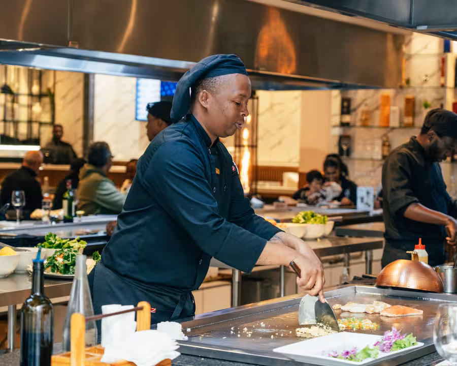 The glamorous golden bar at Gigi Restaurant, offering an upscale dining experience and standing out as one of the most stylish Waterfall Corner restaurants.