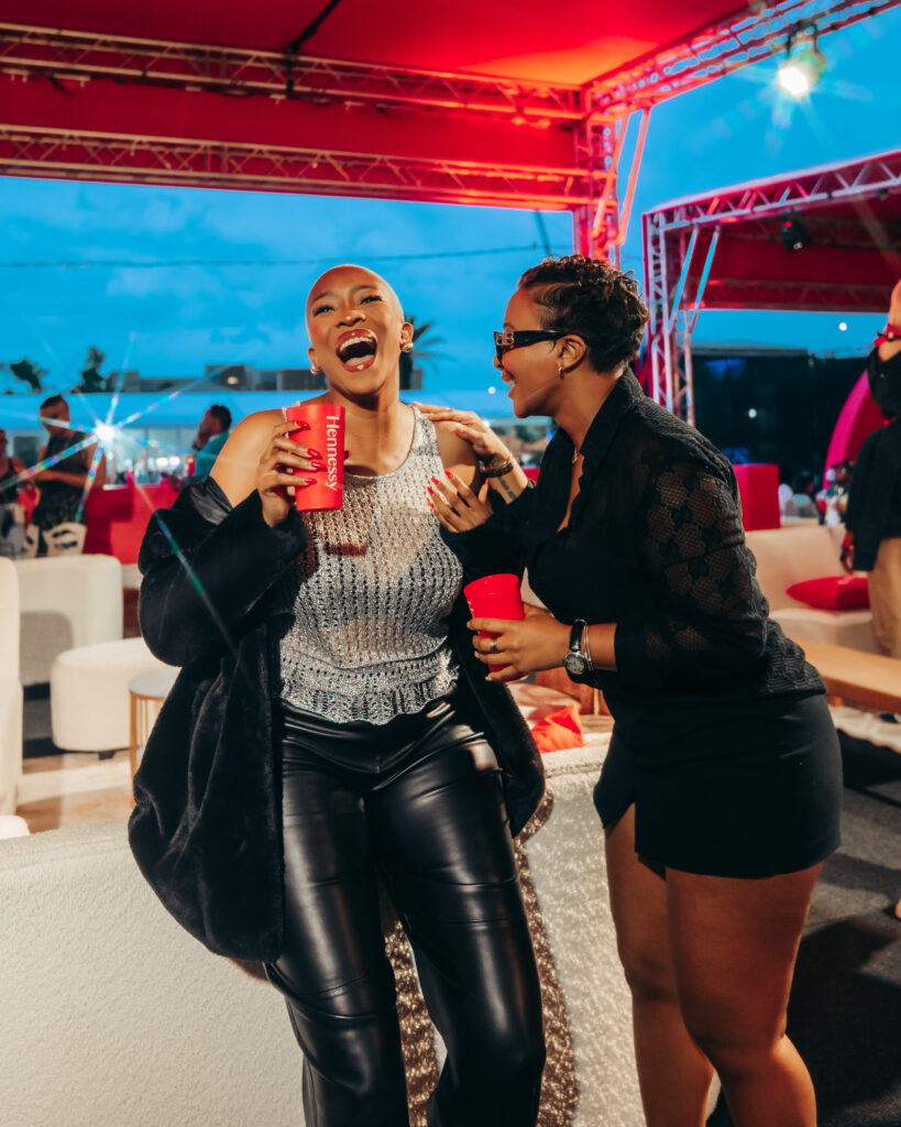 Twiggy Moli and Boity Thulo laughing and enjoying the Hennessy VIP deck at a festival event in Johannesburg.