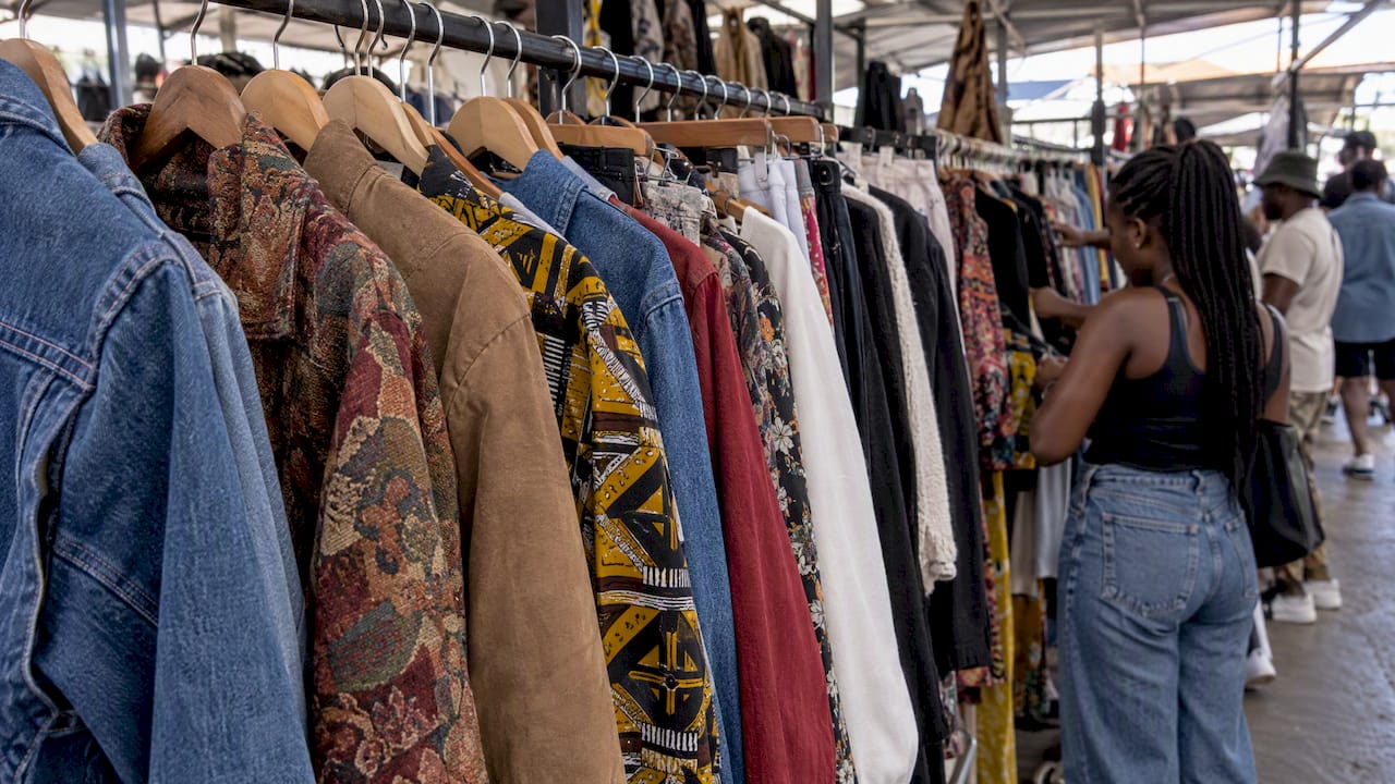 Vintage garments hanging at a market stall