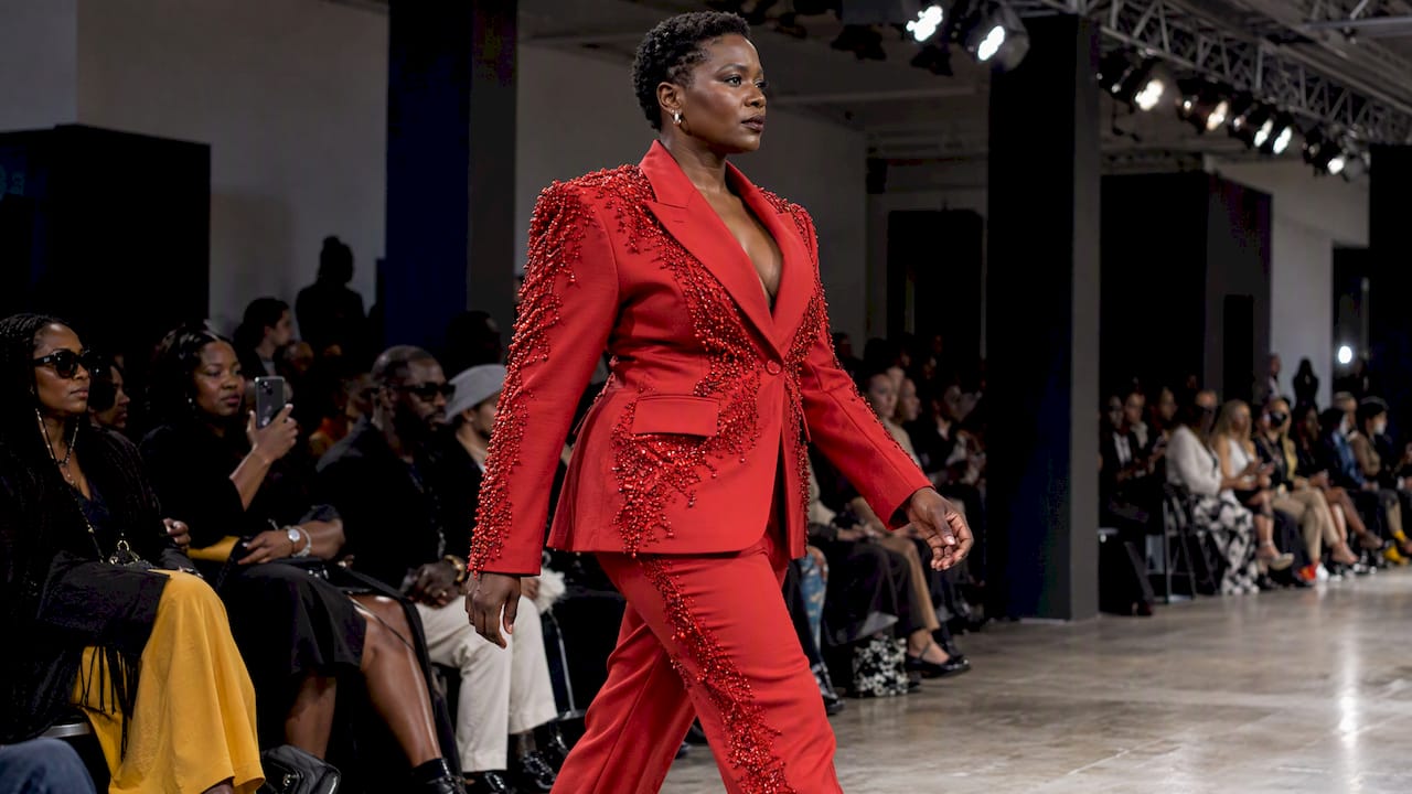 Model wearing a beaded red power suit