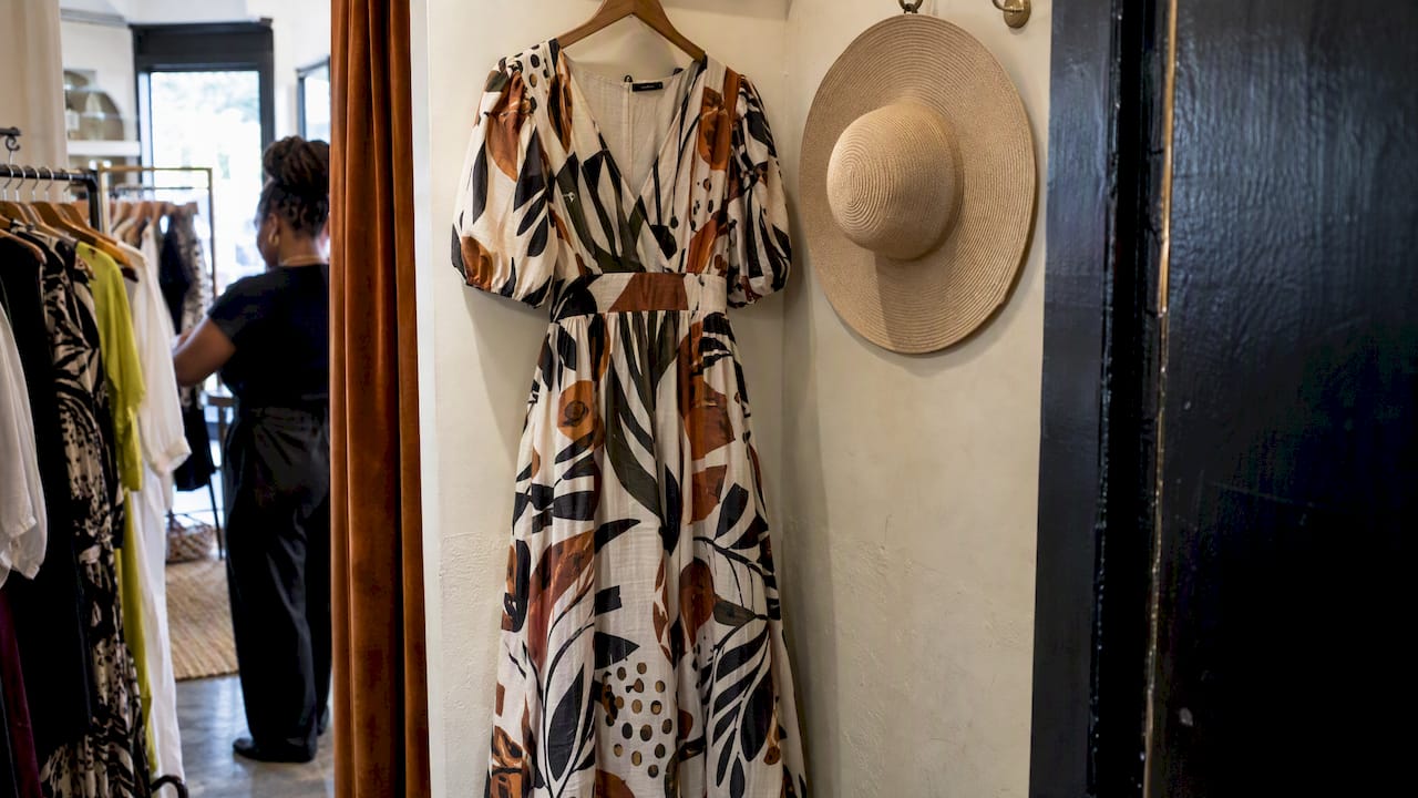 African print midi dress beside a plain hat