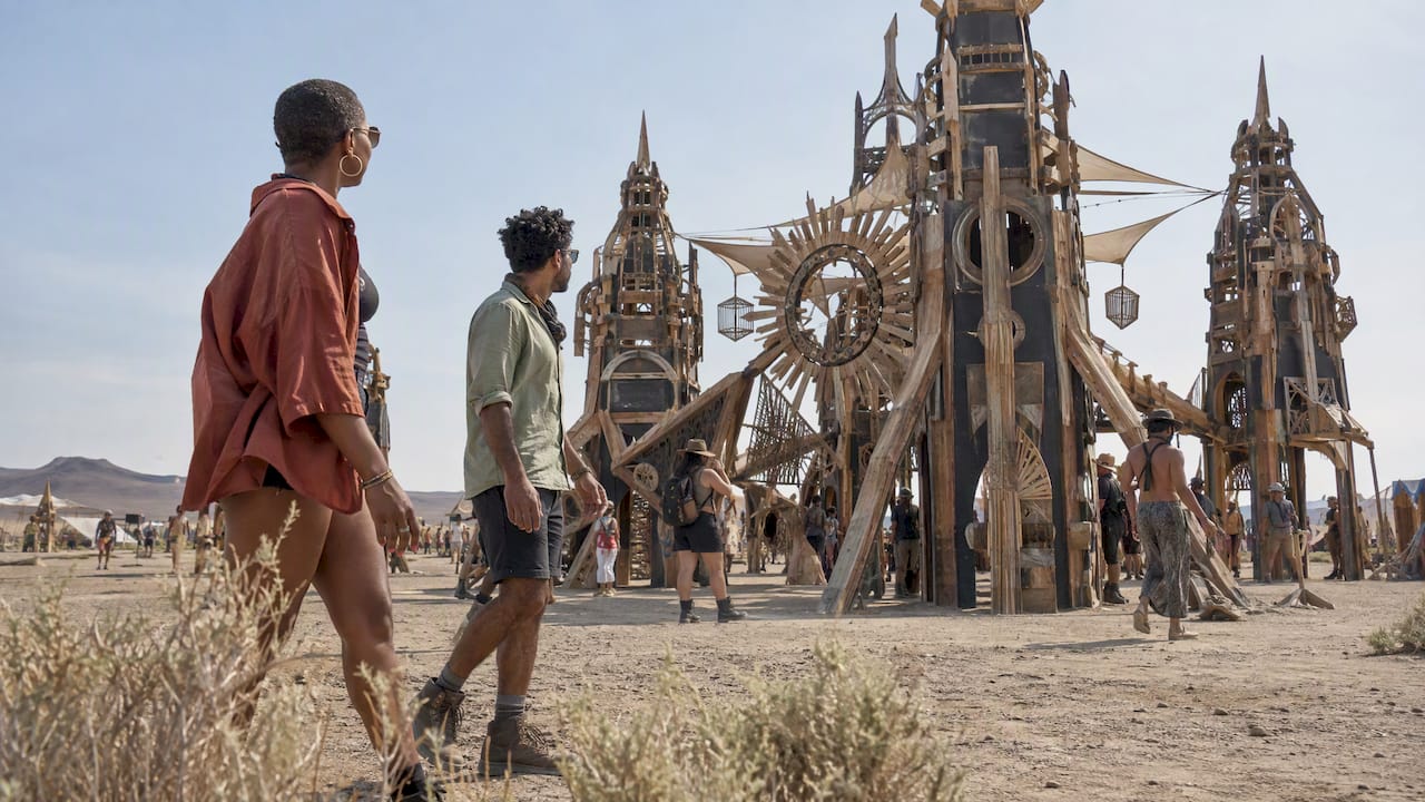 Participants gather around desert festival artwork